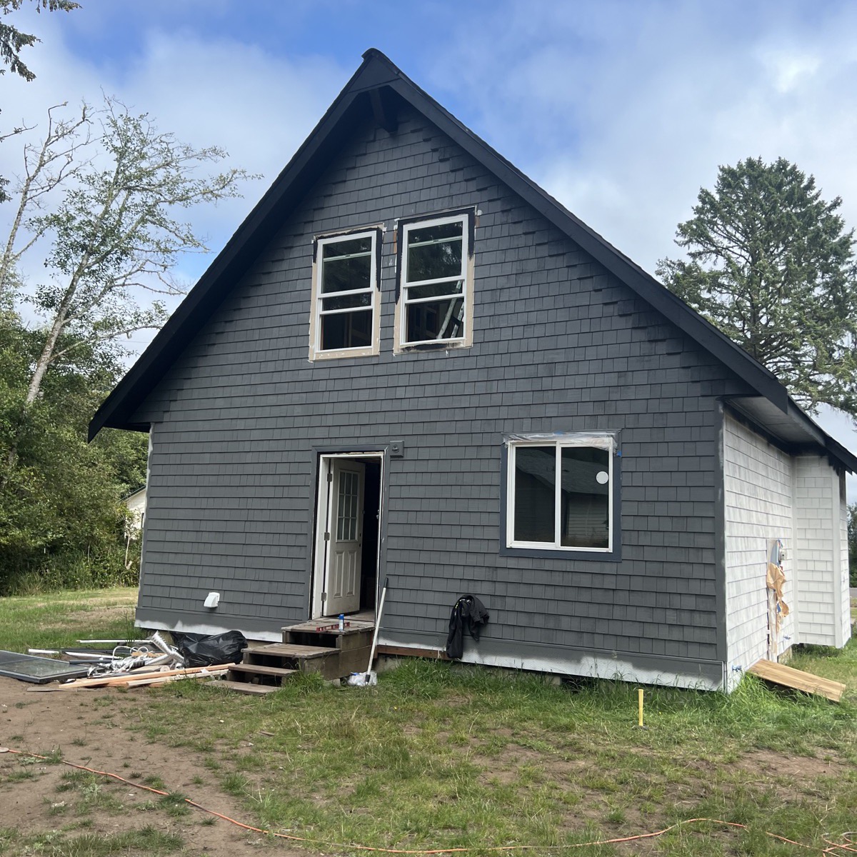 Dark shingle siding installed on a new cabin