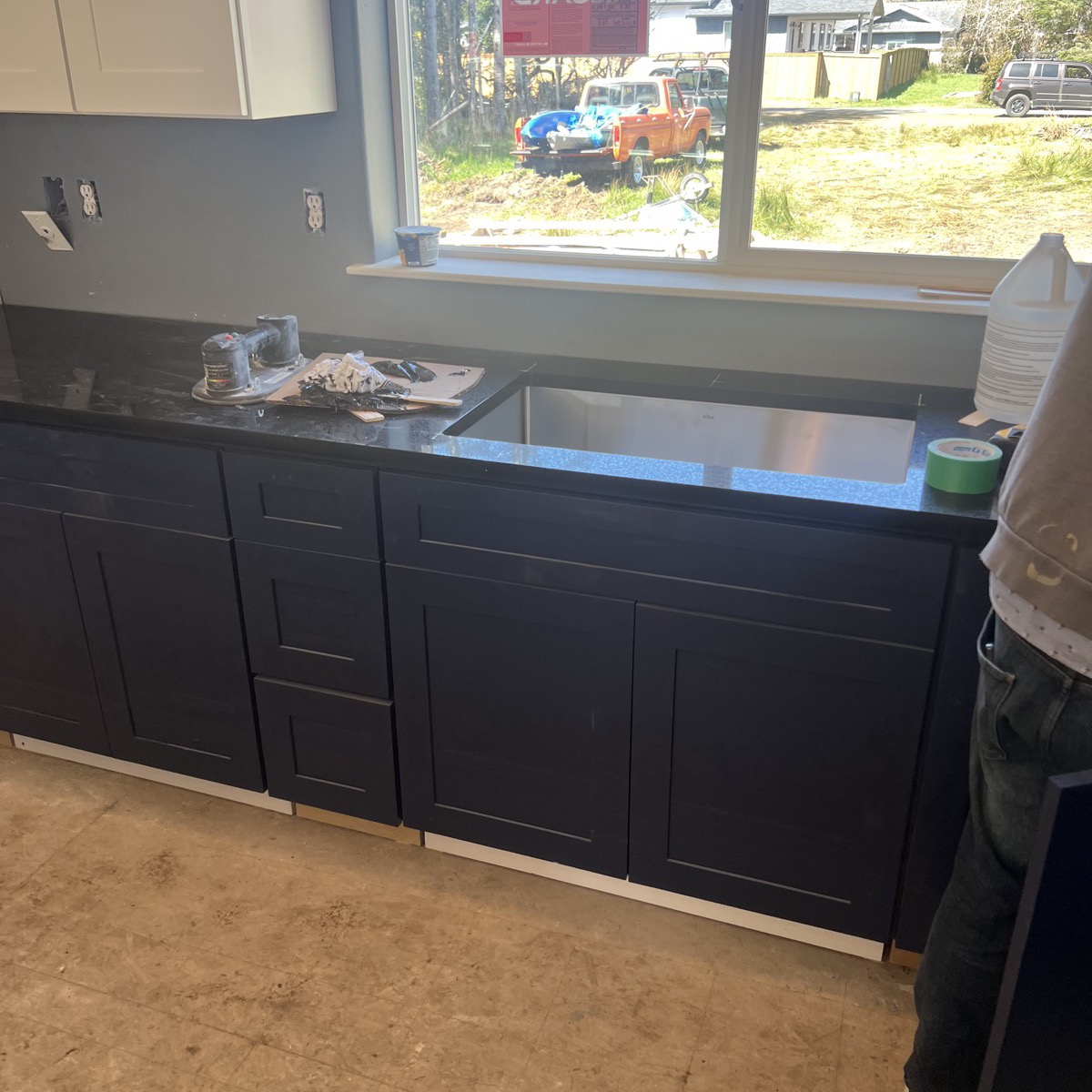 Navy shaker kitchen cabinets during installation