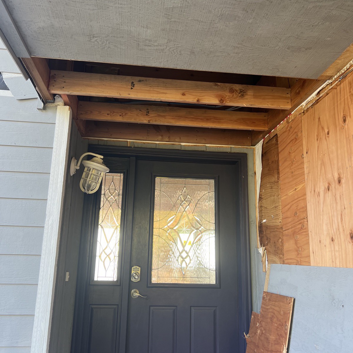 New front door with leaded glass and porch framing
